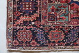 Antique Persian area rug in a living room setting, pile rug, vintage rug, portland, rug shop, bright colors, wild shaman, soft rug, bold color, Portland, Oregon, rug store, rug shop, local shop, antique rug, Persian rug, handmade rug, wool rug, distressed rug