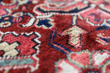 Antique Persian area rug in a living room setting, pile rug, vintage rug, portland, rug shop, bright colors, wild shaman, soft rug, bold color, Portland, Oregon, rug store, rug shop, local shop, antique rug, Persian rug, handmade rug, wool rug, distressed rug