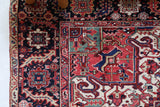 Antique Persian area rug in a living room setting, pile rug, vintage rug, portland, rug shop, bright colors, wild shaman, soft rug, bold color, Portland, Oregon, rug store, rug shop, local shop, antique rug, Persian rug, handmade rug, wool rug, distressed rug