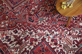 Antique Persian area rug in a living room setting, pile rug, vintage rug, portland, rug shop, bright colors, wild shaman, soft rug, bold color, Portland, Oregon, rug store, rug shop, local shop, antique rug, Persian rug, handmade rug, wool rug, distressed rug
