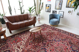 Antique Persian area rug in a living room setting, pile rug, vintage rug, portland, rug shop, bright colors, wild shaman, soft rug, bold color, Portland, Oregon, rug store, rug shop, local shop, antique rug, Persian rug, handmade rug, wool rug, distressed rug