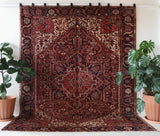 Antique Persian area rug in a living room setting, pile rug, vintage rug, portland, rug shop, bright colors, wild shaman, soft rug, bold color, Portland, Oregon, rug store, rug shop, local shop, antique rug, Persian rug, handmade rug, wool rug, distressed rug
