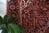 Antique Persian area rug in a living room setting, pile rug, vintage rug, portland, rug shop, bright colors, wild shaman, soft rug, bold color, Portland, Oregon, rug store, rug shop, local shop, antique rug, Persian rug, handmade rug, wool rug, distressed rug