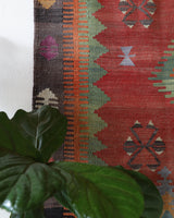 Vintage kilim rug in living room setting, old rug, antique rug, pastel colors, faded colors, Turkish rug, vintage rug, soft rug, Portland, Oregon, rug store, rug shop, local shop, earthy tones, earthy colors, warm colors