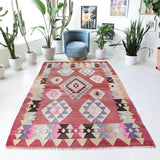 Vintage kilim rug in living room setting, old rug, antique rug, pastel colors, faded colors, Turkish rug, vintage rug, soft rug, Portland, Oregon, rug store, rug shop, local shop, earthy tones, earthy colors, warm colors