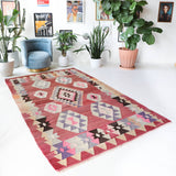 Vintage kilim rug in living room setting, old rug, antique rug, pastel colors, faded colors, Turkish rug, vintage rug, soft rug, Portland, Oregon, rug store, rug shop, local shop, earthy tones, earthy colors, warm colors