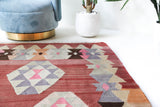 Vintage kilim rug in living room setting, old rug, antique rug, pastel colors, faded colors, Turkish rug, vintage rug, soft rug, Portland, Oregon, rug store, rug shop, local shop, earthy tones, earthy colors, warm colors