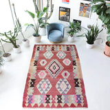 Vintage kilim rug in living room setting, old rug, antique rug, pastel colors, faded colors, Turkish rug, vintage rug, soft rug, Portland, Oregon, rug store, rug shop, local shop, earthy tones, earthy colors, warm colors