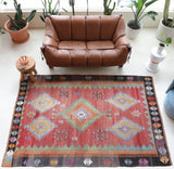 Vintage kilim rug in living room setting, old rug, antique rug, pastel colors, faded colors, Turkish rug, vintage rug, soft rug, Portland, Oregon, rug store, rug shop, local shop, earthy tones, earthy colors, warm colors
