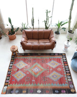 Vintage kilim rug in living room setting, old rug, antique rug, pastel colors, faded colors, Turkish rug, vintage rug, soft rug, Portland, Oregon, rug store, rug shop, local shop, earthy tones, earthy colors, warm colors