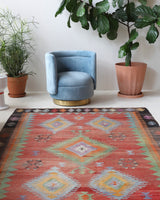Vintage kilim rug in living room setting, old rug, antique rug, pastel colors, faded colors, Turkish rug, vintage rug, soft rug, Portland, Oregon, rug store, rug shop, local shop, earthy tones, earthy colors, warm colors
