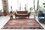 Vintage kilim rug in living room setting, old rug, antique rug, pastel colors, faded colors, Turkish rug, vintage rug, soft rug, Portland, Oregon, rug store, rug shop, local shop, earthy tones, earthy colors, warm colors