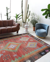 Vintage kilim rug in living room setting, old rug, antique rug, pastel colors, faded colors, Turkish rug, vintage rug, soft rug, Portland, Oregon, rug store, rug shop, local shop, earthy tones, earthy colors, warm colors