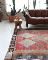 Vintage kilim rug in living room setting, old rug, antique rug, pastel colors, faded colors, Turkish rug, vintage rug, soft rug, Portland, Oregon, rug store, rug shop, local shop, earthy tones, earthy colors, warm colors