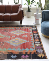 Vintage kilim rug in living room setting, old rug, antique rug, pastel colors, faded colors, Turkish rug, vintage rug, soft rug, Portland, Oregon, rug store, rug shop, local shop, earthy tones, earthy colors, warm colors