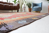 Vintage kilim rug in living room setting, old rug, antique rug, pastel colors, faded colors, Turkish rug, vintage rug, soft rug, Portland, Oregon, rug store, rug shop, local shop, earthy tones, earthy colors, warm colors
