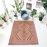 Vintage kilim rug in living room setting, old rug, antique rug, pastel colors, faded colors, Turkish rug, vintage rug, soft rug, Portland, Oregon, rug store, rug shop, local shop, earthy tones, earthy colors, warm colors