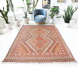 Vintage kilim rug in living room setting, old rug, antique rug, pastel colors, faded colors, Turkish rug, vintage rug, soft rug, Portland, Oregon, rug store, rug shop, local shop, earthy tones, earthy colors, warm colors