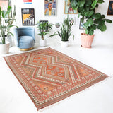 Vintage kilim rug in living room setting, old rug, antique rug, pastel colors, faded colors, Turkish rug, vintage rug, soft rug, Portland, Oregon, rug store, rug shop, local shop, earthy tones, earthy colors, warm colors