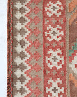 Vintage kilim rug in living room setting, old rug, antique rug, pastel colors, faded colors, Turkish rug, vintage rug, soft rug, Portland, Oregon, rug store, rug shop, local shop, earthy tones, earthy colors, warm colors