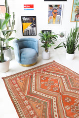 Vintage kilim rug in living room setting, old rug, antique rug, pastel colors, faded colors, Turkish rug, vintage rug, soft rug, Portland, Oregon, rug store, rug shop, local shop, earthy tones, earthy colors, warm colors