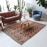 Vintage kilim rug in living room setting, old rug, antique rug, pastel colors, faded colors, Turkish rug, vintage rug, soft rug, Portland, Oregon, rug store, rug shop, local shop, earthy tones, earthy colors, warm colors