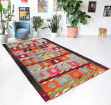 Vintage kilim rug in living room setting, bright colors, wild shaman, soft rug, bold color, Portland, Oregon, rug store, rug shop, local shop, vintage rug, modern kilim, warm colors