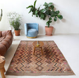 Vintage kilim rug in living room setting, old rug, antique rug, pastel colors, faded colors, Turkish rug, vintage rug, soft rug, Portland, Oregon, rug store, rug shop, local shop, earthy tones, earthy colors, warm colors