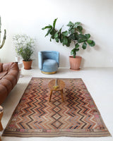 Vintage kilim rug in living room setting, old rug, antique rug, pastel colors, faded colors, Turkish rug, vintage rug, soft rug, Portland, Oregon, rug store, rug shop, local shop, earthy tones, earthy colors, warm colors