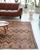 Vintage kilim rug in living room setting, old rug, antique rug, pastel colors, faded colors, Turkish rug, vintage rug, soft rug, Portland, Oregon, rug store, rug shop, local shop, earthy tones, earthy colors, warm colors