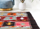 Vintage kilim rug in living room setting, bright colors, wild shaman, soft rug, bold color, Portland, Oregon, rug store, rug shop, local shop, vintage rug, modern kilim, warm colors