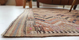 Vintage kilim rug in living room setting, old rug, antique rug, pastel colors, faded colors, Turkish rug, vintage rug, soft rug, Portland, Oregon, rug store, rug shop, local shop, earthy tones, earthy colors, warm colors