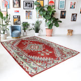 Vintage kilim rug in room decor setting, old rug, antique rug, pastel colors, faded colors, Turkish rug, vintage rug, soft rug, Portland, Oregon, rug store, rug shop, local shop, bold colors, bright colors, faded colors