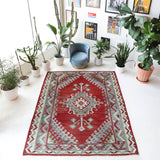 Vintage kilim rug in room decor setting, old rug, antique rug, pastel colors, faded colors, Turkish rug, vintage rug, soft rug, Portland, Oregon, rug store, rug shop, local shop, bold colors, bright colors, faded colors