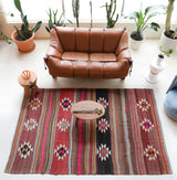 Vintage kilim rug in room decor setting, old rug, antique rug, pastel colors, faded colors, Turkish rug, vintage rug, soft rug, Portland, Oregon, rug store, rug shop, local shop, bold colors, bright colors, faded colors