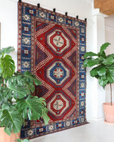 Vintage Turkish rug in a living room setting, pile rug, Turkish rug, vintage rug, portland, rug shop, bright colors, wild shaman, soft rug, bold color, Portland, Oregon, rug store, rug shop, local shop, antique rug