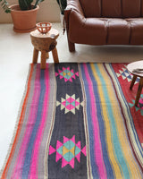 Vintage kilim rug in living room setting, bright colors, wild shaman, soft rug, bold color, Portland, Oregon, rug store, rug shop, local shop, vintage rug, modern kilim, warm colors