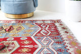 Vintage kilim rug in living room setting, bright colors, wild shaman, soft rug, bold color, Portland, Oregon, rug store, rug shop, local shop, vintage rug, modern kilim, warm colors, antique kilim rug