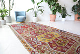 Vintage kilim rug in living room setting, bright colors, wild shaman, soft rug, bold color, Portland, Oregon, rug store, rug shop, local shop, vintage rug, modern kilim, warm colors, antique kilim rug