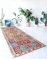 Vintage kilim rug in living room setting, bright colors, wild shaman, soft rug, bold color, Portland, Oregon, rug store, rug shop, local shop, vintage rug, modern kilim, warm colors, antique kilim rug