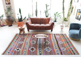 Vintage kilim rug in room decor setting, old rug, antique rug, pastel colors, faded colors, Turkish rug, vintage rug, soft rug, Portland, Oregon, rug store, rug shop, local shop, bold colors, bright colors, faded colors