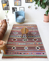 Vintage kilim rug in room decor setting, old rug, antique rug, pastel colors, faded colors, Turkish rug, vintage rug, soft rug, Portland, Oregon, rug store, rug shop, local shop, bold colors, bright colors, faded colors