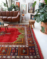 Vintage Turkish rug in a living room setting, pile rug, Turkish rug, vintage rug, portland, rug shop, bright colors, wild shaman, soft rug, bold color, Portland, Oregon, rug store, rug shop, local shop, antique rug