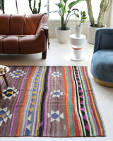 Vintage kilim rug in room decor setting, old rug, antique rug, pastel colors, faded colors, Turkish rug, vintage rug, soft rug, Portland, Oregon, rug store, rug shop, local shop, bold colors, bright colors, faded colors