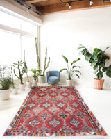 Vintage kilim rug in living room setting, old rug, antique rug, pastel colors, faded colors, Turkish rug, vintage rug, soft rug, Portland, Oregon, rug store, rug shop, local shop, earthy tones, earthy colors, warm colors