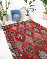 Vintage kilim rug in living room setting, old rug, antique rug, pastel colors, faded colors, Turkish rug, vintage rug, soft rug, Portland, Oregon, rug store, rug shop, local shop, earthy tones, earthy colors, warm colors