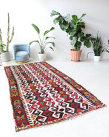 Vintage kilim rug in room decor setting, old rug, antique rug, pastel colors, faded colors, Turkish rug, vintage rug, soft rug, Portland, Oregon, rug store, rug shop, local shop, antique kilim rug, bold colors, bright colors