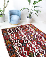 Vintage kilim rug in room decor setting, old rug, antique rug, pastel colors, faded colors, Turkish rug, vintage rug, soft rug, Portland, Oregon, rug store, rug shop, local shop, antique kilim rug, bold colors, bright colors