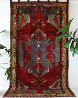 Vintage Turkish rug in a living room setting, pile rug, Turkish rug, vintage rug, portland, rug shop, bright colors, wild shaman, soft rug, bold color, Portland, Oregon, rug store, rug shop, local shop, antique rug