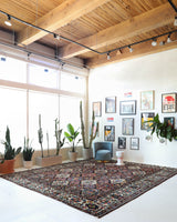 Antique Persian area rug in a living room setting, pile rug, vintage rug, portland, rug shop, bright colors, wild shaman, soft rug, bold color, Portland, Oregon, rug store, rug shop, local shop, antique rug, Persian rug, handmade rug, wool rug, distressed rug